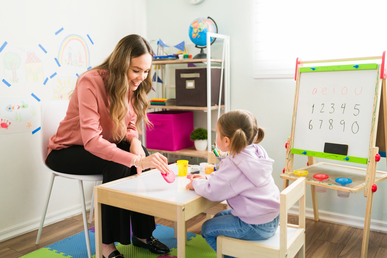 Therapist using clay to play with a preschooler during child therapy